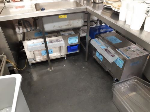 Kitchen Work Preparation and grease Trap in use 