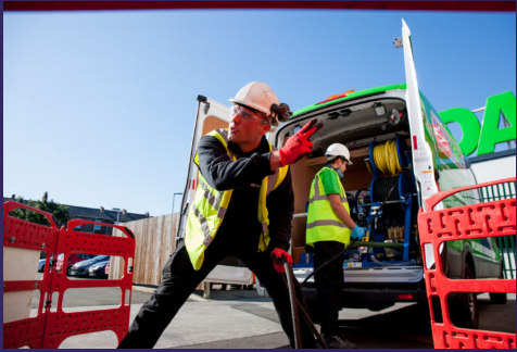 Image of Men Unblocking a drain on the road